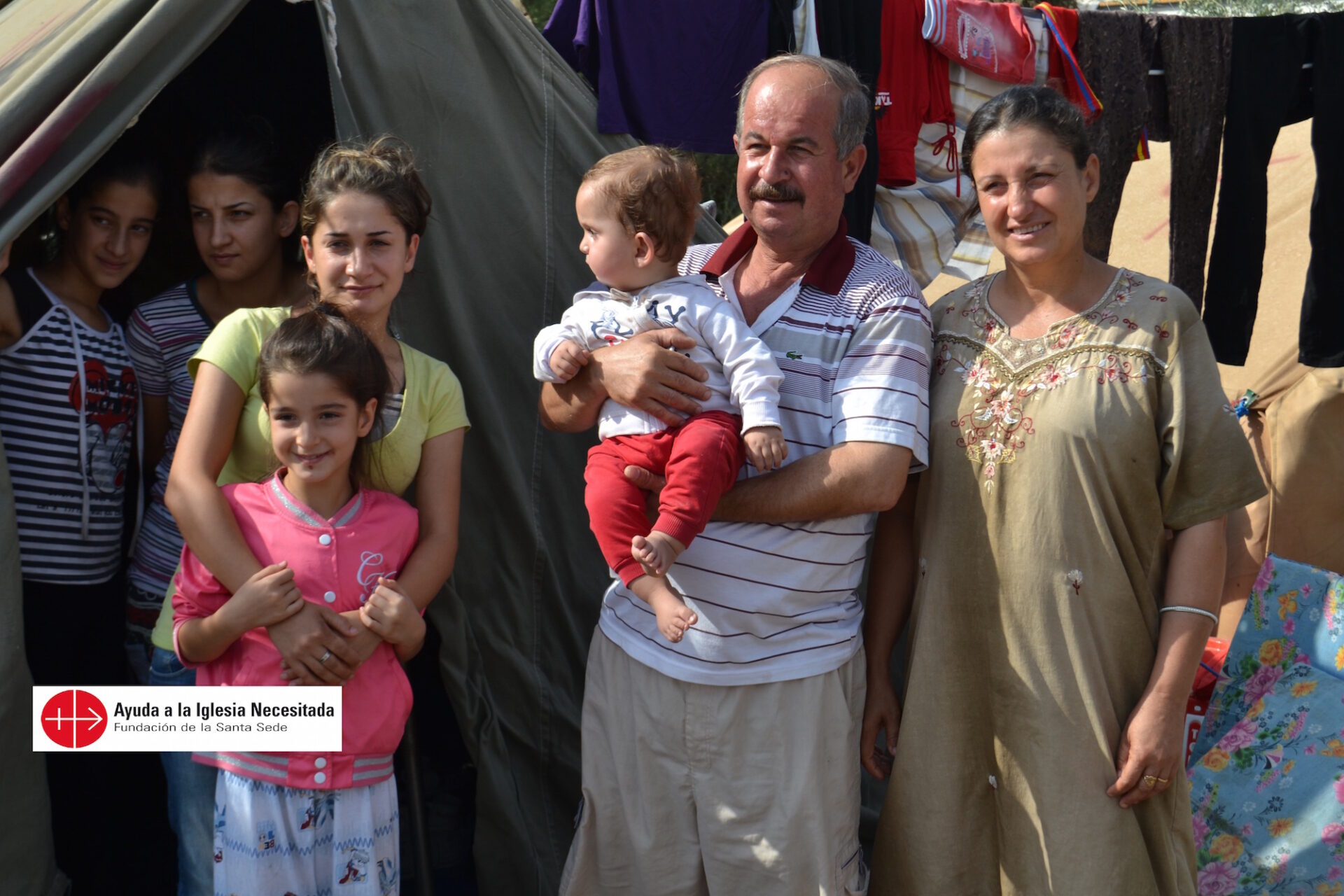 A family from Qaraqosh in front of their tent; At the St. Elia shrine, a centre for the IDPs from QaraqoshIRAQ / MOSSUL-CLD 14/00054Emergency help for refugees from Christian villages around  Mosul (Mossul)after recent ISIL attacksIraq 02-07.10.2014